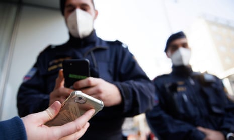 police in masks check phone