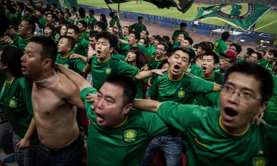 Fans of Beijing Guoan celebrate a goal.
