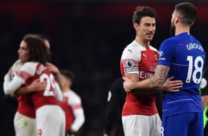 Arsenal's Laurent Koscielny (center) talks to his former team-mate Olivier Giroud.