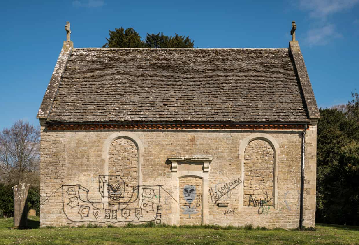 Spray paint on Holy Rood church in Swindon. Photograph: Historic England