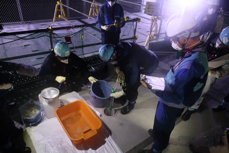 Tepco workers take water samples during preparations for the initial discharge of treated water at the Fukushima Daiichi nuclear power plant.