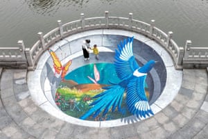 Handan, China. People stop to look at a 3D street mural