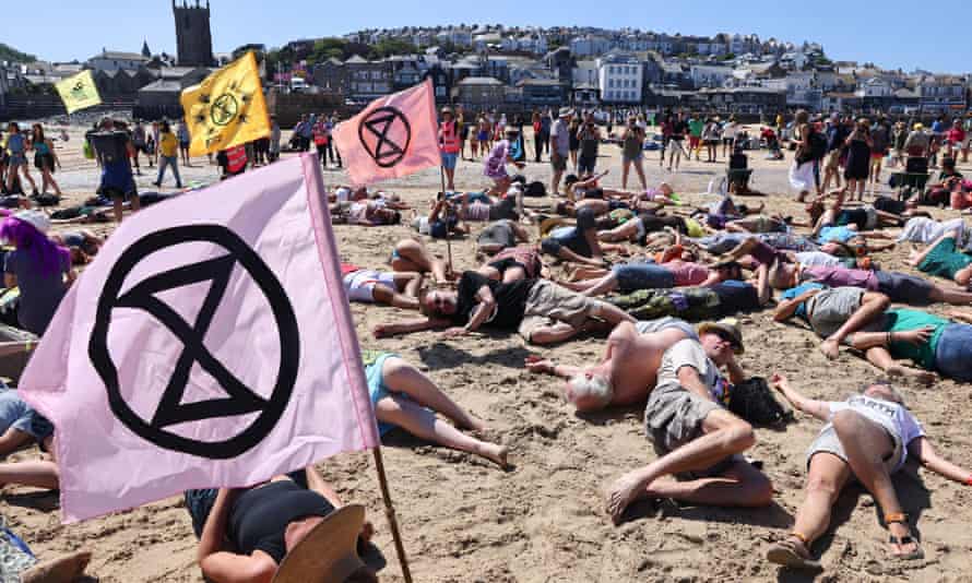 Extinction Rebellion demonstrators protest on the beach in St Ives during the G7 summit in Cornwall