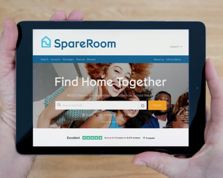 A man looks at the SpareRoom website on his iPad tablet device