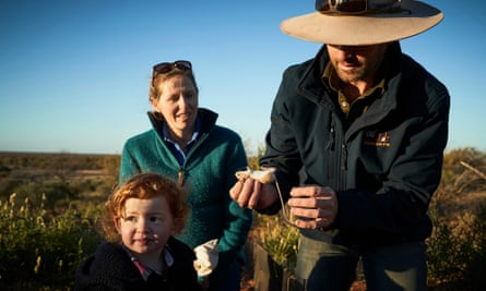 An ecologist and his family weigh and measure a hopping mouse at the Wild Deserts site