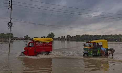 Two rickshaws on a flooded street