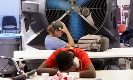 People try to keep cool at a resource center in Phoenix catering to the homeless population, as temperatures hit 110F in July.