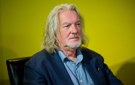 Celebrity sitter … head and shoulders shot of presenter James May wearing a light blue shirt and dark blue jacket, sitting in a chair against a green background.