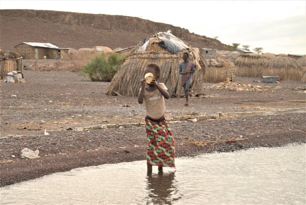 A young girl drinks highly saline water from Lake Turkana in Kenya