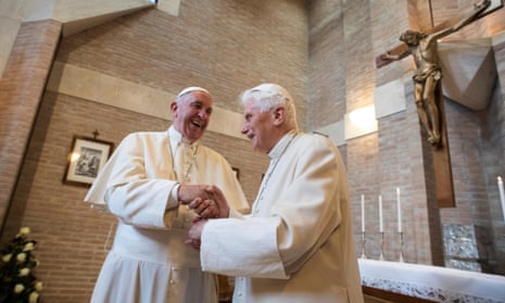 Pope Francis, left, greets Pope Emeritus Benedict XVI