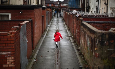 A child playing in a deprived area of Manchester.