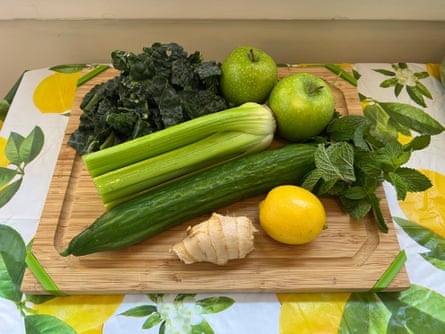fruits and vegetables on a cutting board before juicing