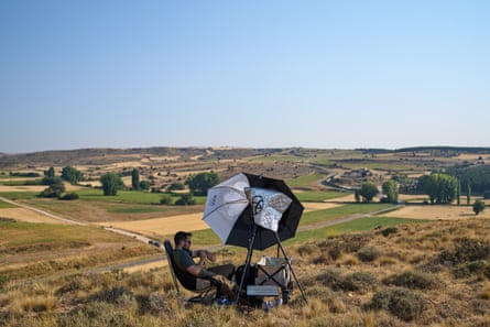 Mario Garrido, a member of the “Los Taraos” amateur astrophotography group, waits to shoot a total solar eclipse in Berlanga de Duero, central Spain