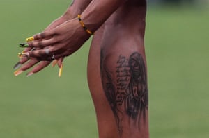 The painted nails and tattooed leg of Jamaica’s sprinter Ashanti Moore.