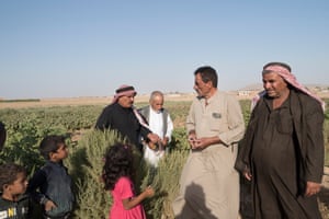 Mohammed Abdo (centre) talks to local farmers.