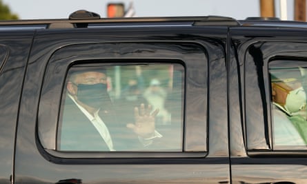 A car with Donald Trump drives past supporters outside Walter Reed medical center in Bethesda, Maryland, on 4 October.