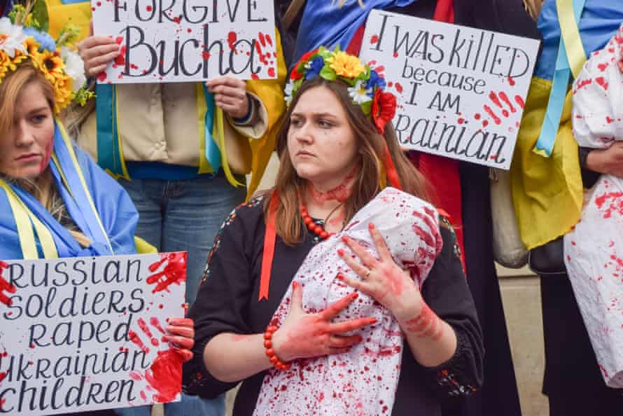 Demonstrators held ‘babies’ and signs covered in fake blood in protest against the massacre in the town of Bucha and atrocities reportedly committed by Russian forces in Ukraine.