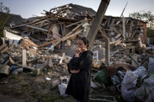 Anna Shevchenko next to destroyed home