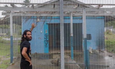 Behrouz Boochani, pictured here in 2018, outside the naval base on Manus Island where he and the other refugees were locked for the first three years on the island.