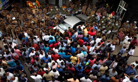 A crowd gathers outside the state-run Ceylon Petroleum Corporation office in Colombo, where the shooting took place