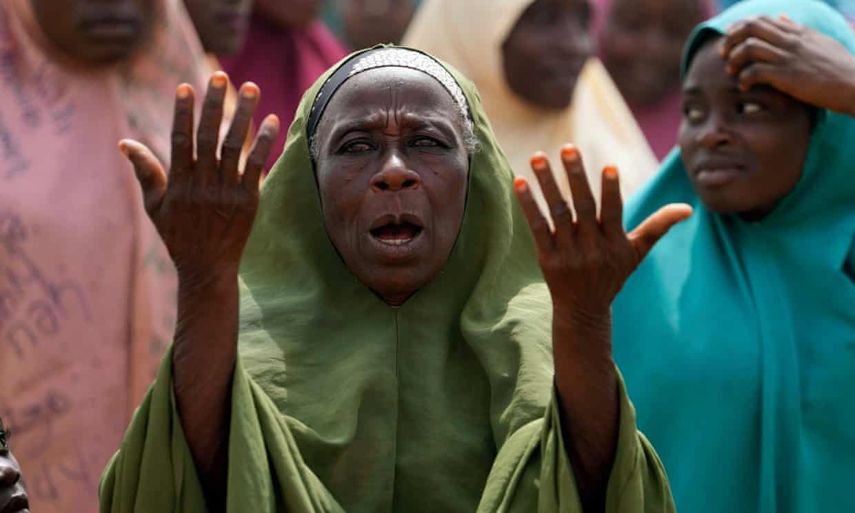 A woman prays for the kidnapped pupils in Kuriga, Kaduna state. Photograph: Sunday Alamba/AP