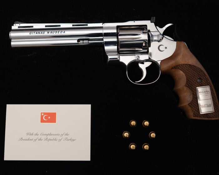 Turkish president gives Nato leaders engraved guns and bullets at summit