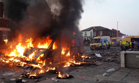 A burning police vehicle during disorder in Southport, Merseyside, on 30 July 2024.  