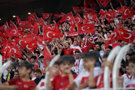 Turkey fans chant slogans and activity flags earlier a World Cup warm-up friends successful Istanbul