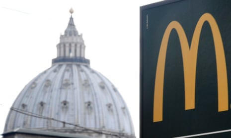 A sign for the Vatican’s first McDonald’s restaurant, seen with the cupola of St Peter’s in the background.