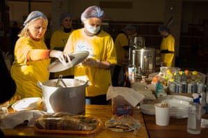Volunteers from the initiative called Sila Uzhhoroda (The Power of Uzhhorod) prepare meals for refugees at a train station in Uzhhorod in Ukraine, kilometres from the border with Slovakia.