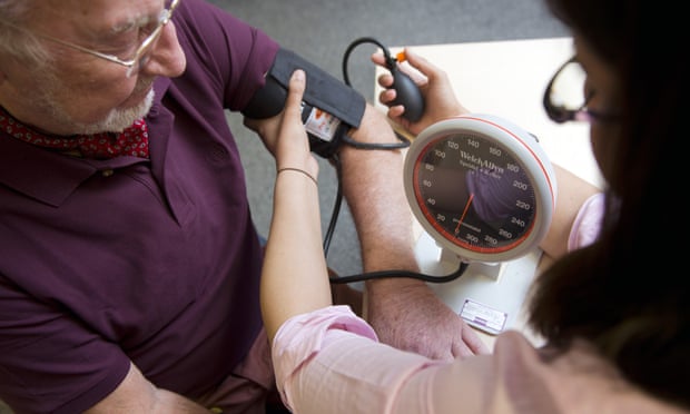 A gp gives a patient a blood pressure test
