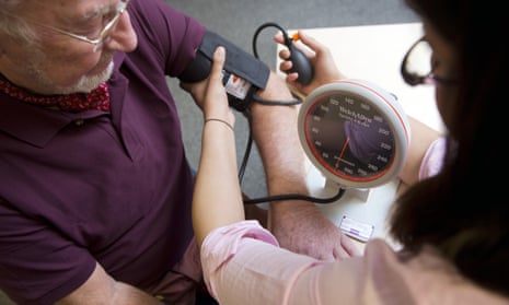 GP testing patient's blood pressure