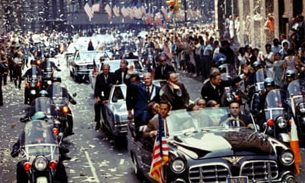 The returning Apollo 11 crew, Buzz Aldrin, Michael Collins and Neil Armstrong, seen left to right in the lead car, are showered in ticker tape during a parade down Broadway and Park Avenue in New York, on 13 August 1969.