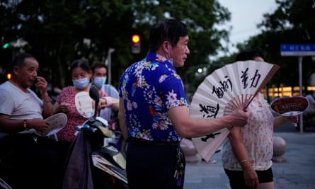 People fan themselves during a heatwave in Shanghai, China.