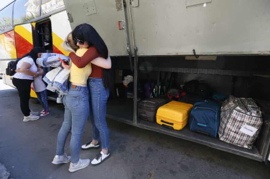 Refugees react in Odesa as they bid farewell before taking a bus on an evacuation trip to Italy organised by a Ukrainian volunteer initiative.