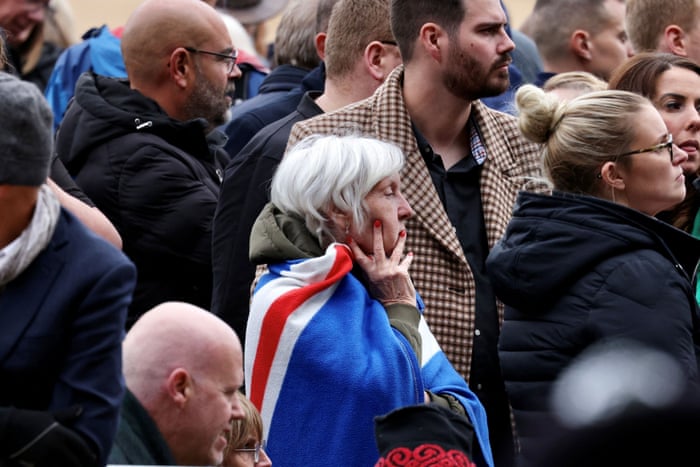 Members of the public wait near Horse Guards Parade.