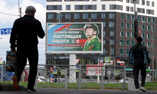 A billboard that reads “Serving Russia is a real job” in St Petersburg.