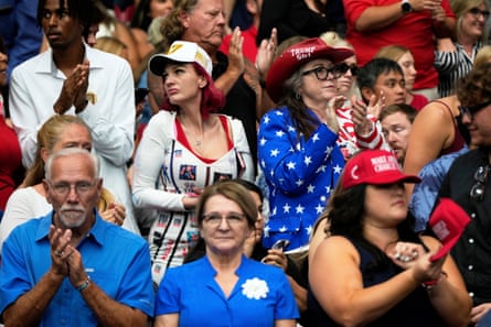 a group of people wearing red, white and blue clothing clap in crowd