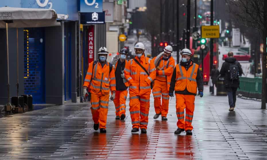 Construction workers walk down Oxford Street in London