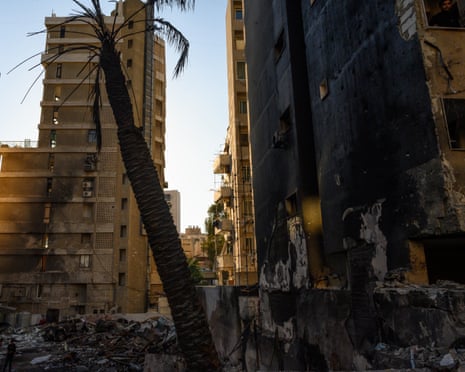 A burnt palm tree marks a building destroyed in the Corniche al-Masraa neighborhood of Beirut by Israeli strikes on 8 April that hit 100 targets in 10 minutes across Lebanon