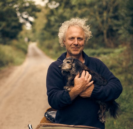 Charlie Mackesy holding a dog.