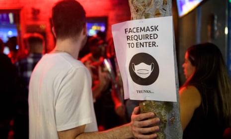 Face mask signage is displayed outside the Trunks bar after midnight in the early morning on July, 2021 in West Hollywood, California.
