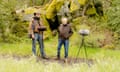 Two men stand with sound booms in a state park in California