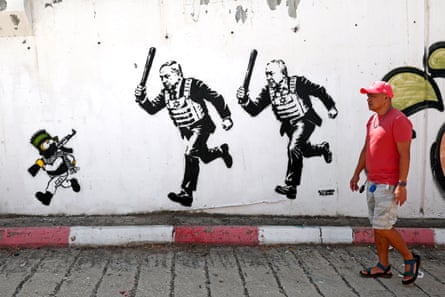 A mural titled RUN by artist Alexsandro Palombo, depicting Israeli prime minister Benjamin Netanyahu and politician Gadi Eisenkot wearing bulletproof vests and carrying batons as they chase Bart Simpson, portrayed as a young Hamas fighter, in Tel Aviv