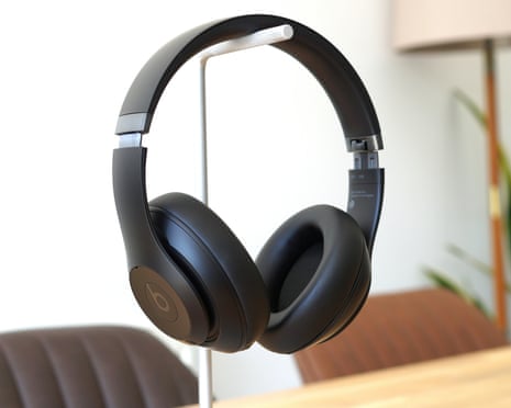 Beats Studio Pro review hanging on a headphone stand.