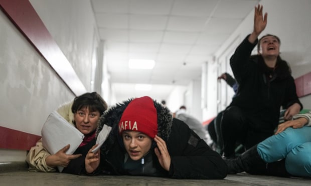 The family is lying on the floor