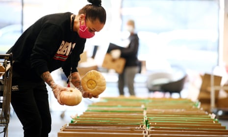 A volunteer fills boxes for a food bank in Auckland, New Zealand