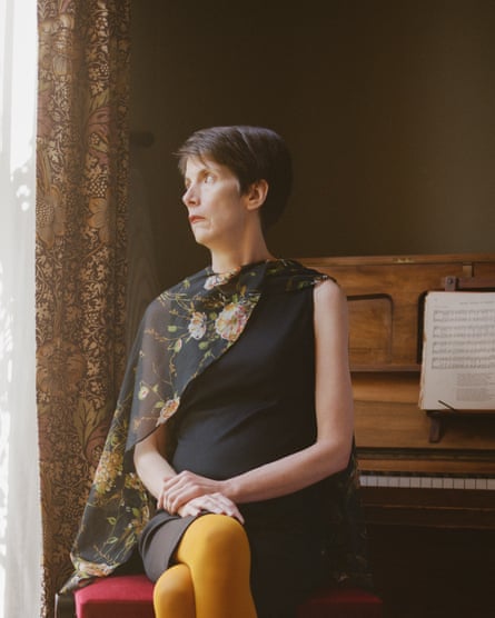 Charlotte Raven at home next to a piano