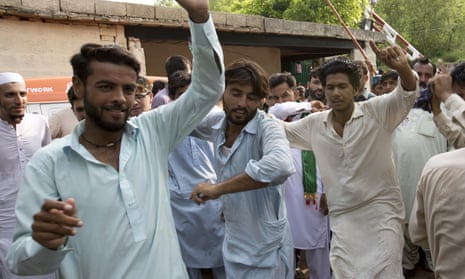 Supporters of Imran Khan dance in celebration outside his home in Islamabad on Thursday.