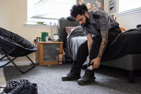 A man in a security uniform putting on shoes